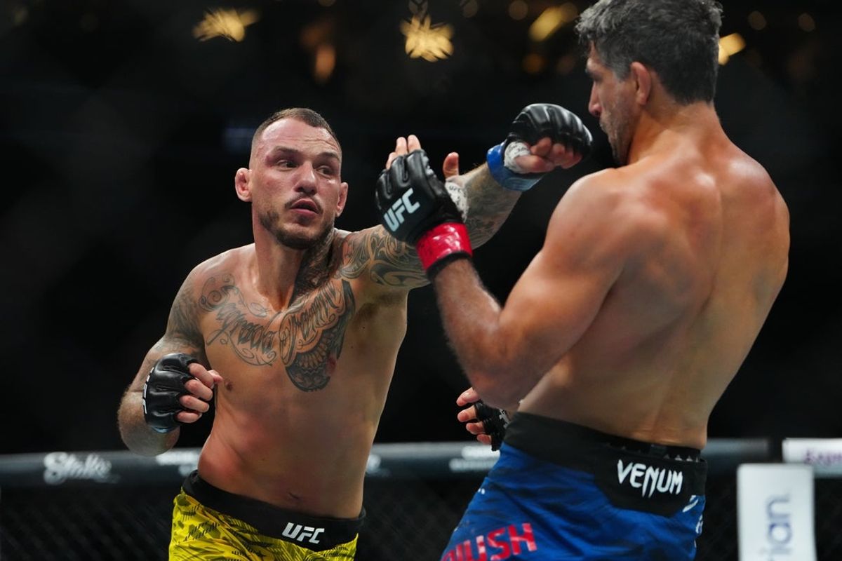 Jun 28, 2025; Las Vegas, Nevada, USA; Beneil Dariush (red gloves) fights Renato Moicano (blue gloves) during UFC 317 at T-Mobile Arena. Mandatory Credit: Stephen R. Sylvanie-Imagn Images