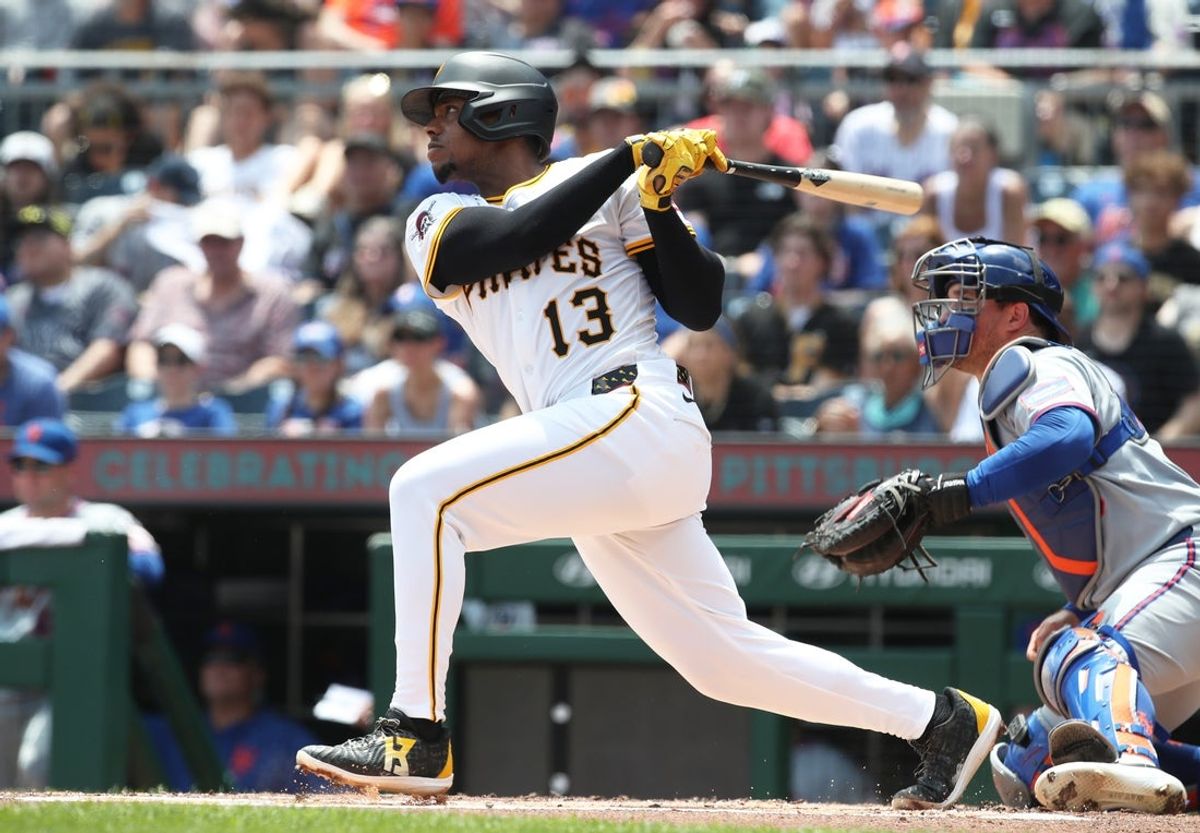 Jun 29, 2025; Pittsburgh, Pennsylvania, USA;  Pittsburgh Pirates third baseman Ke'Bryan Hayes (13) hits a two run single against the New York Mets during the first inning at PNC Park. Mandatory Credit: Charles LeClaire-Imagn Images