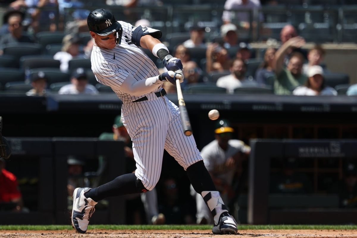 Jun 29, 2025; Bronx, New York, USA; New York Yankees designated hitter Aaron Judge (99) hits a two-run homer during the fourth inning against the Athletics at Yankee Stadium. Mandatory Credit: Vincent Carchietta-Imagn Images
