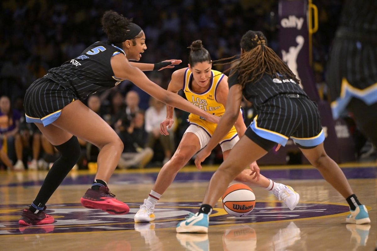 Jun 29, 2025; Los Angeles, California, USA; Los Angeles Sparks guard Kelsey Plum (10) is double teamed by Chicago Sky forward Angel Reese (5) and guard Ariel Atkins (7) in the first half at Crypto.com Arena. Mandatory Credit: Jayne Kamin-Oncea-Imagn Images