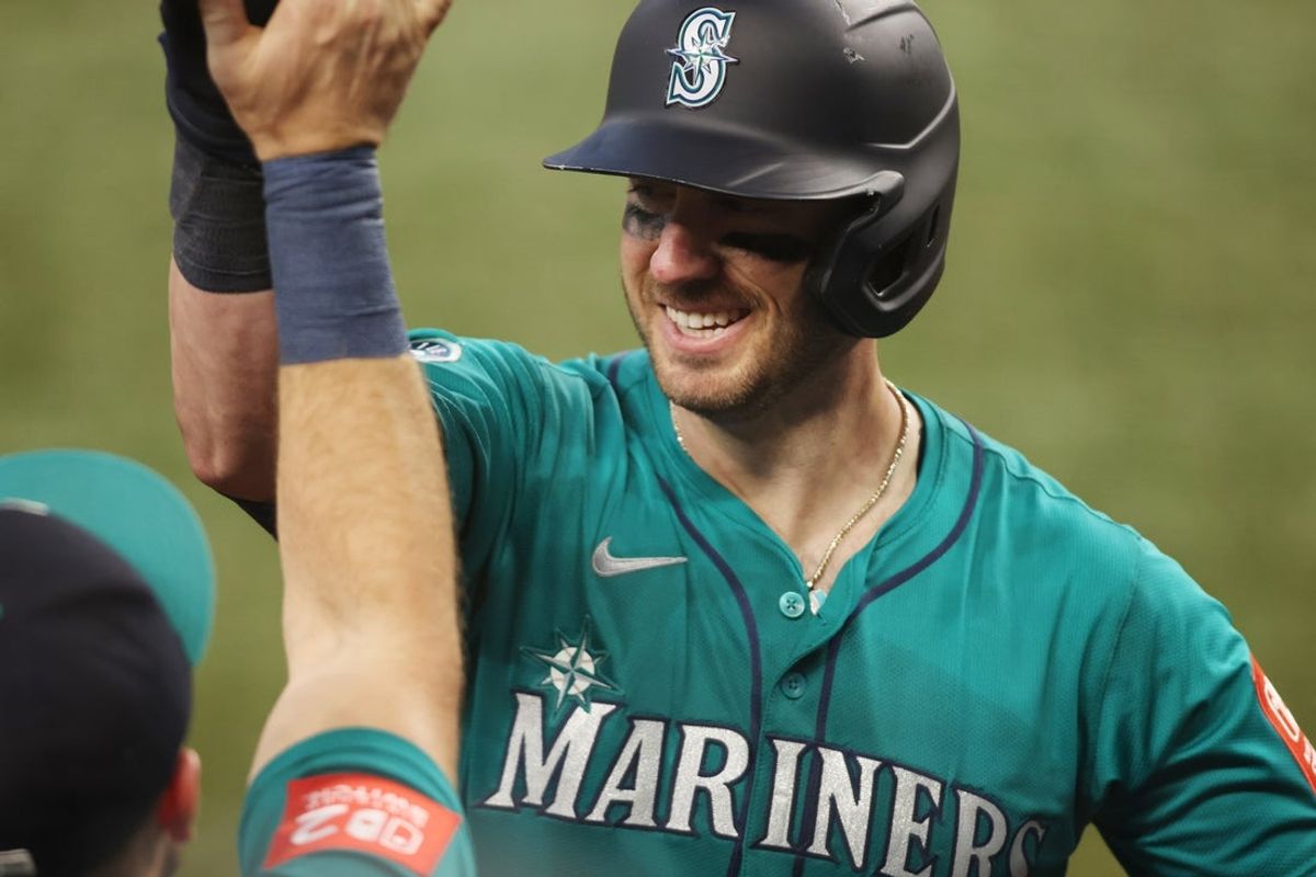 Jun 29, 2025; Arlington, Texas, USA; Seattle Mariners catcher Mitch Garver (18) is congratulated after hitting a two run home run during the twelfth inning against the Texas Rangers at Globe Life Field. Mandatory Credit: Tim Heitman-Imagn Images