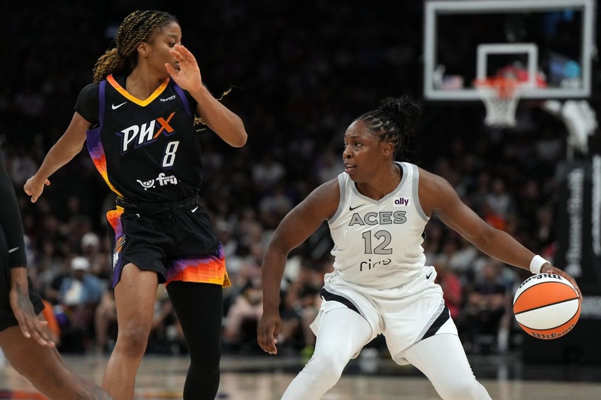 Jun 29, 2025; Phoenix, Arizona, USA; Las Vegas Aces guard Chelsea Gray (12) shields the ball from Phoenix Mercury guard Monique Akoa Makani (8) in the first half at Footprint Center. Mandatory Credit: Rick Scuteri-Imagn Images