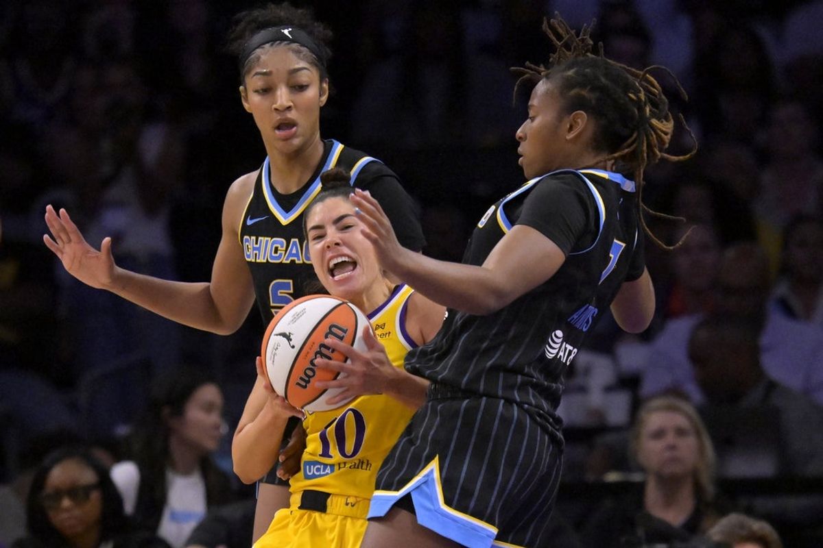 Jun 29, 2025; Los Angeles, California, USA; Los Angeles Sparks guard Kelsey Plum (10) is defended by Chicago Sky forward Angel Reese (5) and guard Ariel Atkins (7) in the second half at Crypto.com Arena. Mandatory Credit: Jayne Kamin-Oncea-Imagn Images