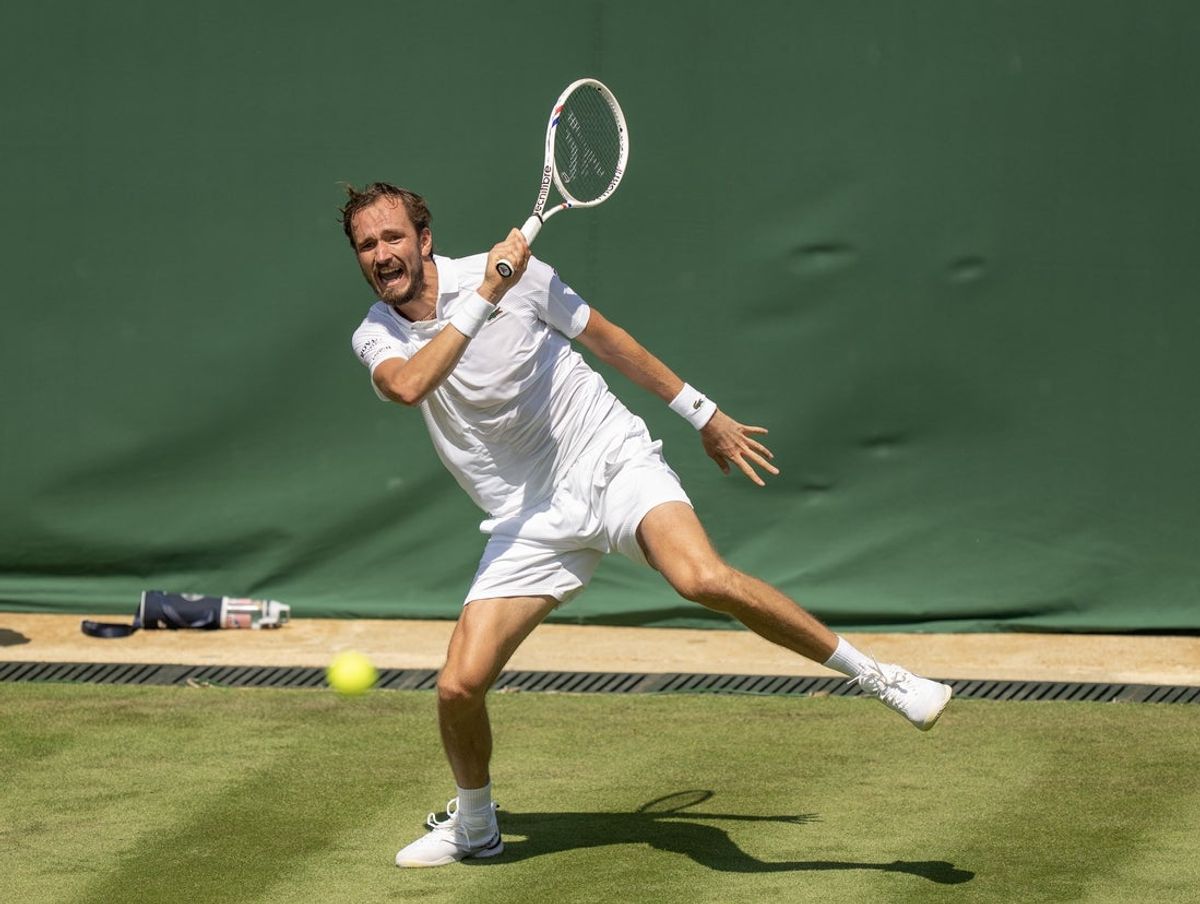 Jun 30, 2025; Wimbledon, UNITED KINGDOM; Daniil Medvedev returns a shot during his match against Benjamin Bonzi of France on day one at the All England Lawn Tennis and Croquet Club. Mandatory Credit: Susan Mullane-Imagn Images