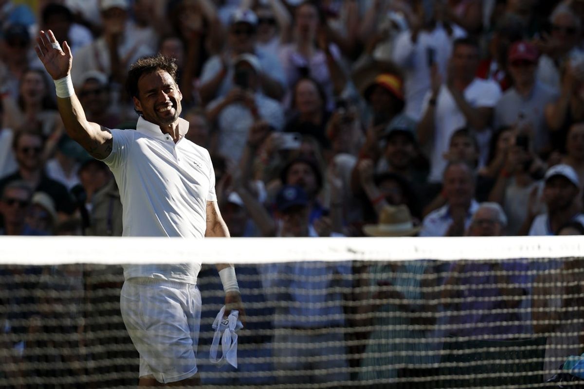 Jun 30, 2025; Wimbledon, United Kingdom; Fabio Fognini (ITA) waves to the crowd while leaving the court after his match against Carlos Alcaraz (ESP)(not pictured) in what is his final match at Wimbledon on day one of The Championships, Wimbledon 2025 at All England Lawn Tennis and Croquet Club. Mandatory Credit: Geoff Burke-Imagn Images