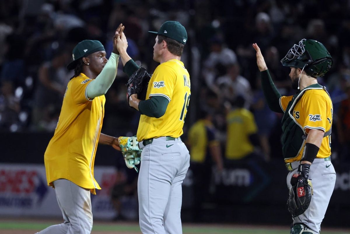 Jun 30, 2025; Tampa, Florida, USA;  Athletics pitcher Mason Miller (19) and outfielder Lawrence Butler (4) celebrate after they beat the Tampa Bay Rays at George M. Steinbrenner Field. Mandatory Credit: Kim Klement Neitzel-Imagn Images