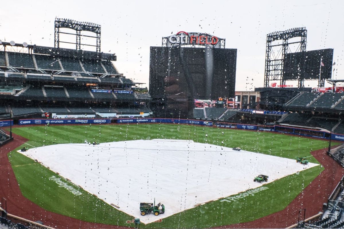 Jul 1, 2025; New York City, New York, USA; Tarp covers the field at Citi Field . The game between the New York Mets and the Milwaukee Brewers was postponed due to impending weather.  Mandatory Credit: Vincent Carchietta-Imagn Images