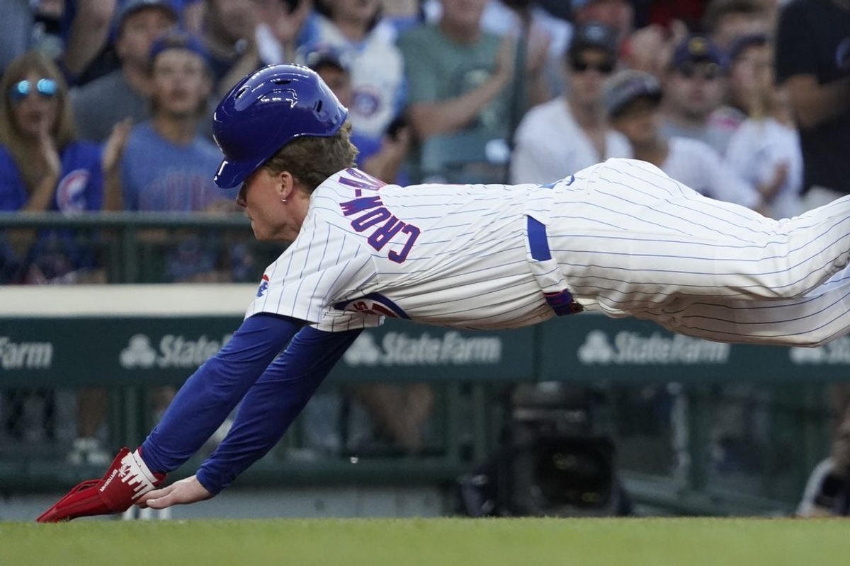 Jul 1, 2025; Chicago, Illinois, USA; Chicago Cubs outfielder Pete Crow-Armstrong (4) slides into third base safely against the Cleveland Guardians during the second inning at Wrigley Field. Mandatory Credit: David Banks-Imagn Images