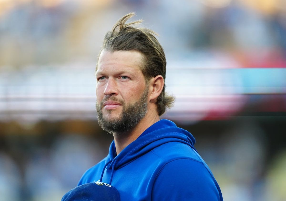 Jul 1, 2025; Los Angeles, California, USA; Los Angeles Dodgers relief pitcher Clayton Kershaw (22) stands for the national anthem prior to a game against the Chicago White Sox at Dodger Stadium. Mandatory Credit: Kirby Lee-Imagn Images