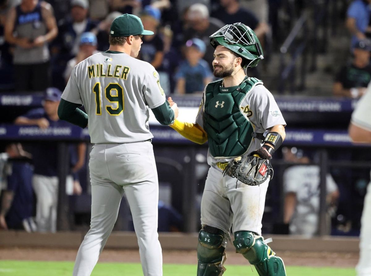 Jul 1, 2025; St. Petersburg, Florida, USA; Athletics pitcher Mason Miller (19) and catcher Shea Langeliers (23) celebrates after they beat the Tampa Bay Rays at George M. Steinbrenner Field. Mandatory Credit: Kim Klement Neitzel-Imagn Images