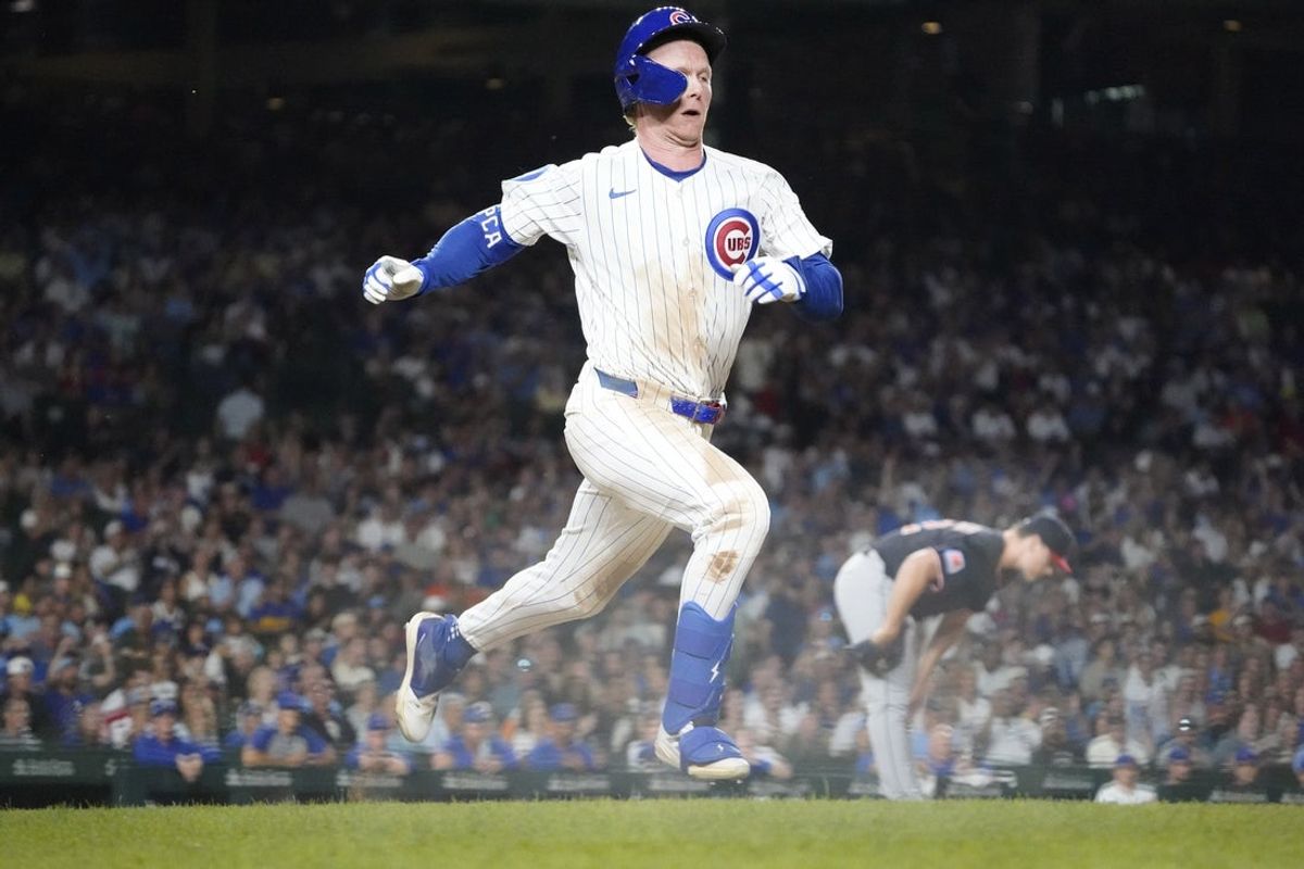 Jul 1, 2025; Chicago, Illinois, USA; Chicago Cubs outfielder Pete Crow-Armstrong (4) beats out an infield single against the Cleveland Guardians during the eighth inning at Wrigley Field. Mandatory Credit: David Banks-Imagn Images
