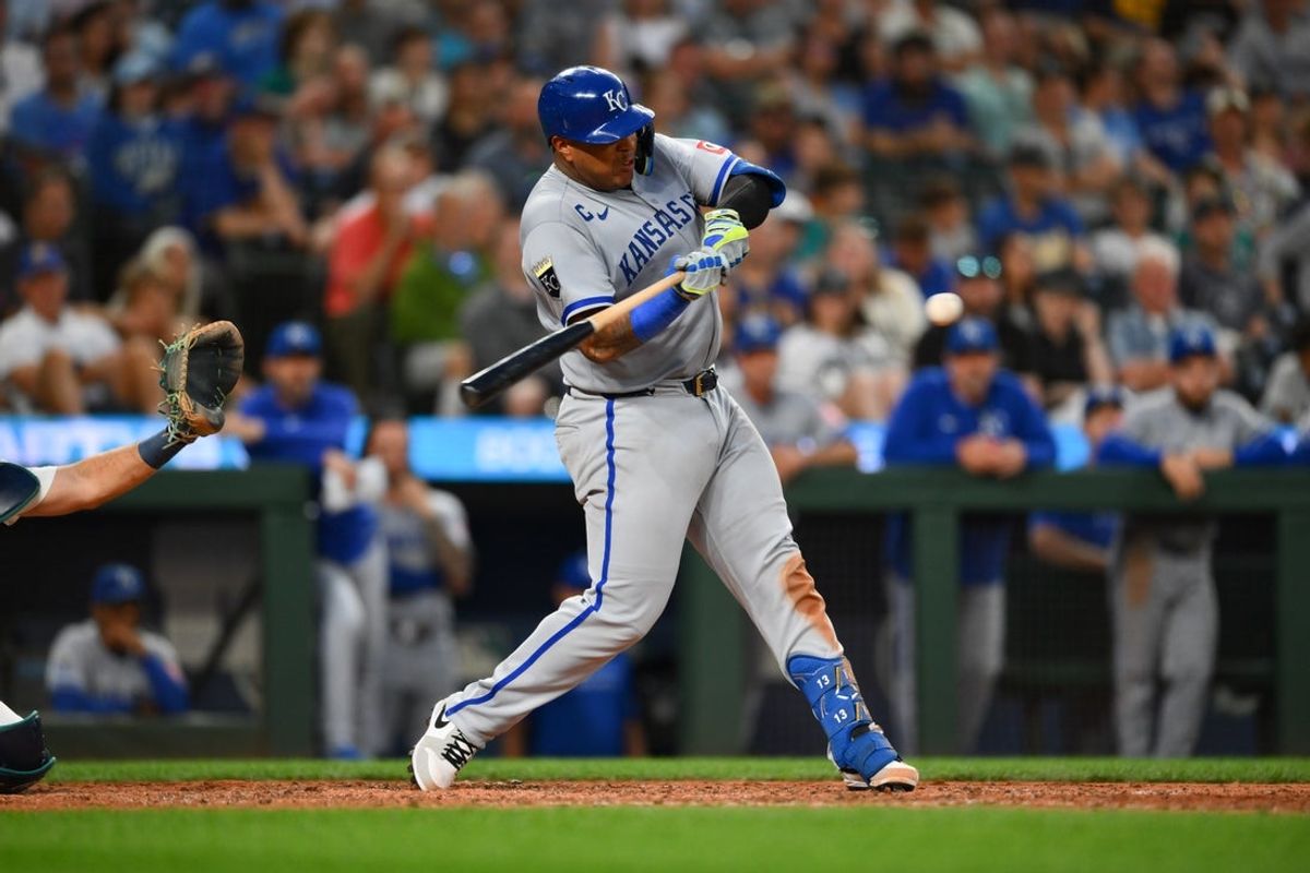 Jul 1, 2025; Seattle, Washington, USA; Kansas City Royals catcher Salvador Perez (13) hits an RBI single against the Seattle Mariners during the ninth inning at T-Mobile Park. Mandatory Credit: Steven Bisig-Imagn Images