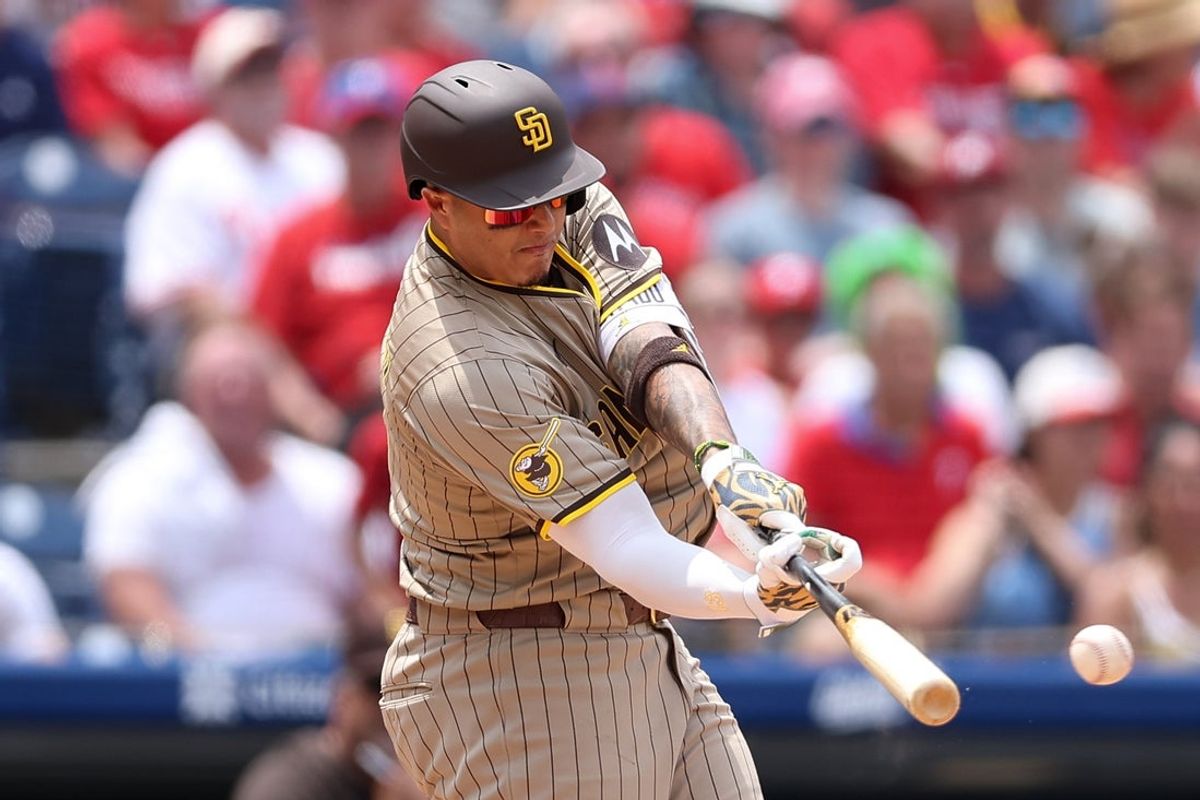Jul 2, 2025; Philadelphia, Pennsylvania, USA; San Diego Padres third base Manny Machado (13) hits a three RBI double during the second inning against the Philadelphia Phillies at Citizens Bank Park. Mandatory Credit: Bill Streicher-Imagn Images