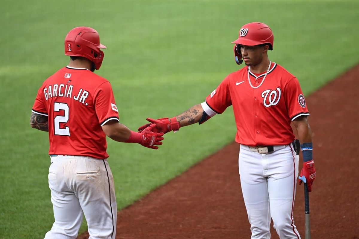 Jul 2, 2025; Washington, District of Columbia, USA; Washington Nationals second baseman Luis Garcia Jr. (2) celebrates with right fielder Daylen Lile (51) after scoring a run against the Detroit Tigers during the first inning at Nationals Park. Mandatory Credit: Rafael Suanes-Imagn Images