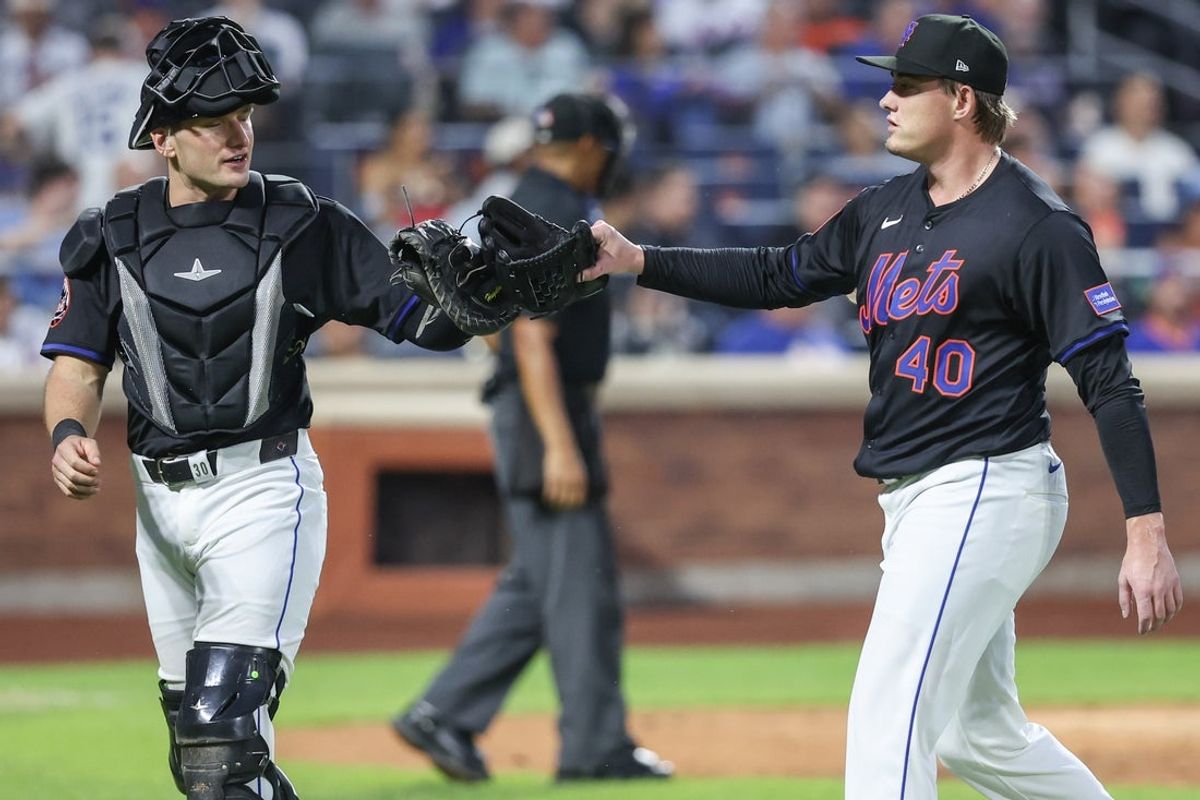 Jul 2, 2025; New York City, New York, USA; New York Mets catcher Hayden Senger (30) congratulates relief pitcher Blade Tidwell (40) after retiring the side in the fifth inning against the Milwaukee Brewers at Citi Field. Mandatory Credit: Wendell Cruz-Imagn Images