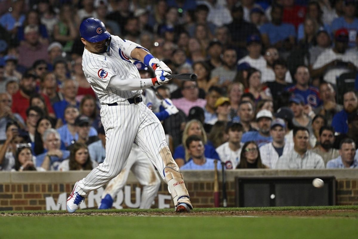 Jul 2, 2025; Chicago, Illinois, USA;  Chicago Cubs designated hitter Seiya Suzuki (27)  hits an two- RBI single against the Cleveland Guardians during the fourth inning at Wrigley Field. Mandatory Credit: Matt Marton-Imagn Images