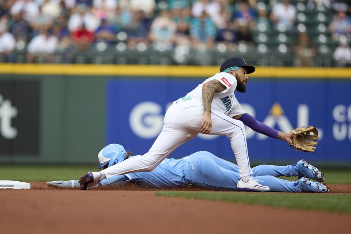 Jul 2, 2025; Seattle, Washington, USA; Kansas City Royals shortstop Bobby Witt Jr. (7) steals second as Seattle Mariners shortstop J.P. Crawford (3) waits for the throw at T-Mobile Park. Mandatory Credit: John Froschauer-Imagn Images