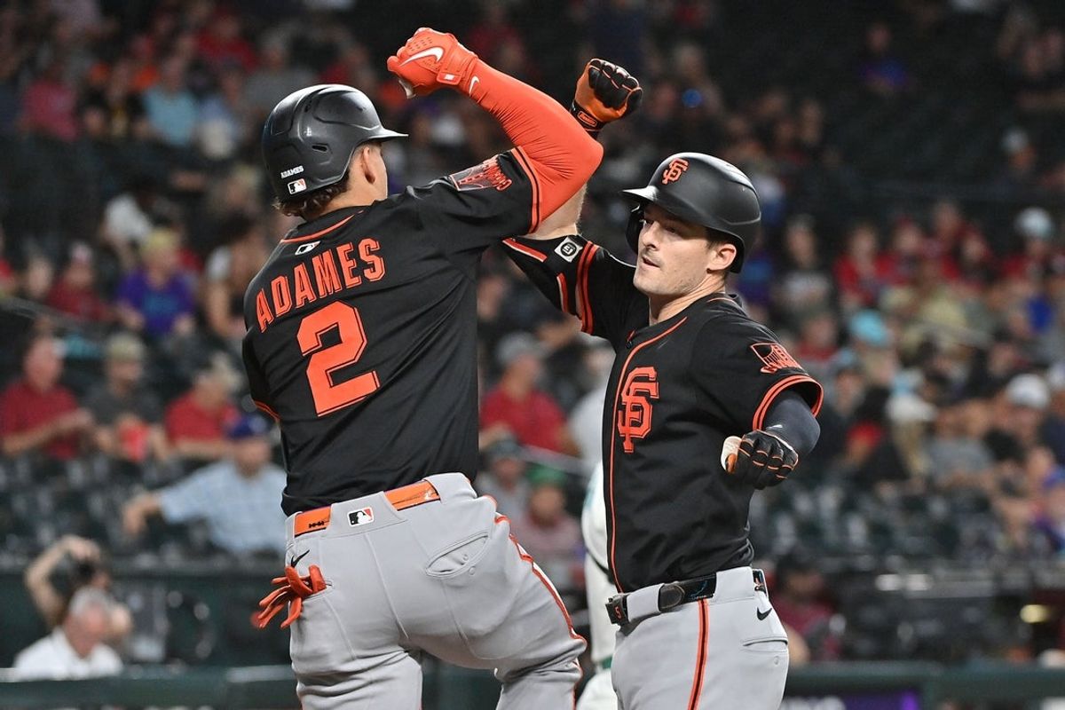 Jul 2, 2025; Phoenix, Arizona, USA;  San Francisco Giants outfielder Mike Yastrzemski (5) celebrates with shortstop Willy Adames (2) after hitting a solo home run in the first inning against the Arizona Diamondbacks at Chase Field. Mandatory Credit: Matt Kartozian-Imagn Images