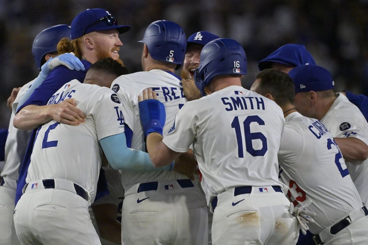 Jul 2, 2025; Los Angeles, California, USA;  Los Angeles Dodgers players celebrate as they surround first baseman Freddie Freeman (5) after he hit a walk-off single during the ninth inning against the Chicago White Sox at Dodger Stadium. Mandatory Credit: Jayne Kamin-Oncea-Imagn Images
