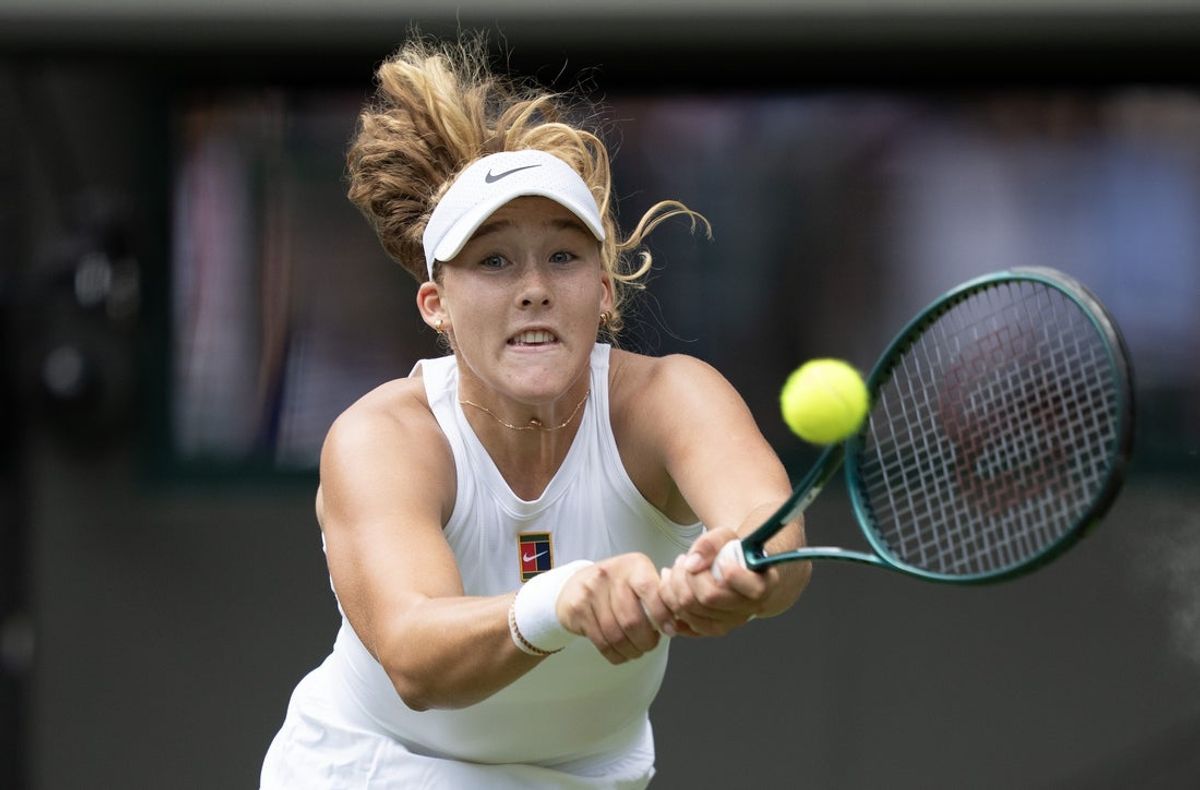 Jul 3, 2025; Wimbledon, United Kingdom; Mirra Andreeva returns a shot during her match against Lucia Bronzetti of Italy on day four at the All England Lawn Tennis and Croquet Club. Mandatory Credit: Susan Mullane-Imagn Images