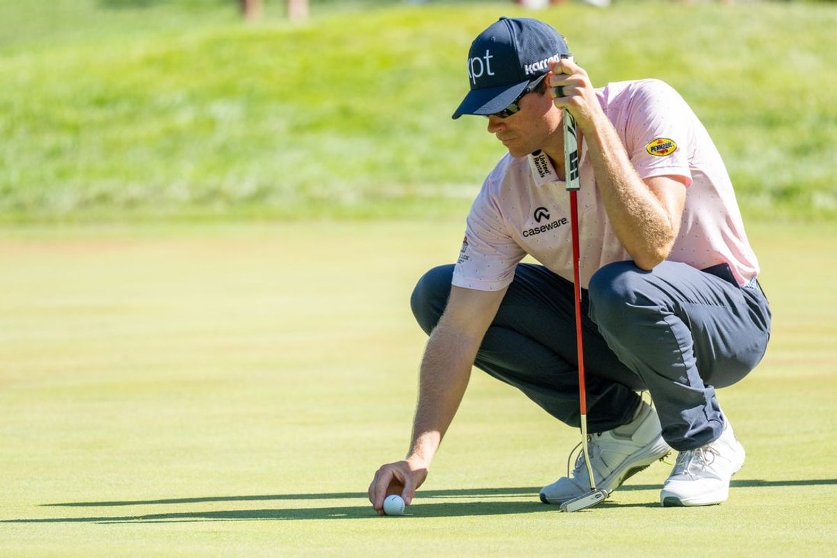 Jul 3, 2025; Silvis, Illinois, USA; Adam Schenk lines up his putt on the 9th green during the first round of the John Deere Classic golf tournament. Mandatory Credit: Marc Lebryk-Imagn Images