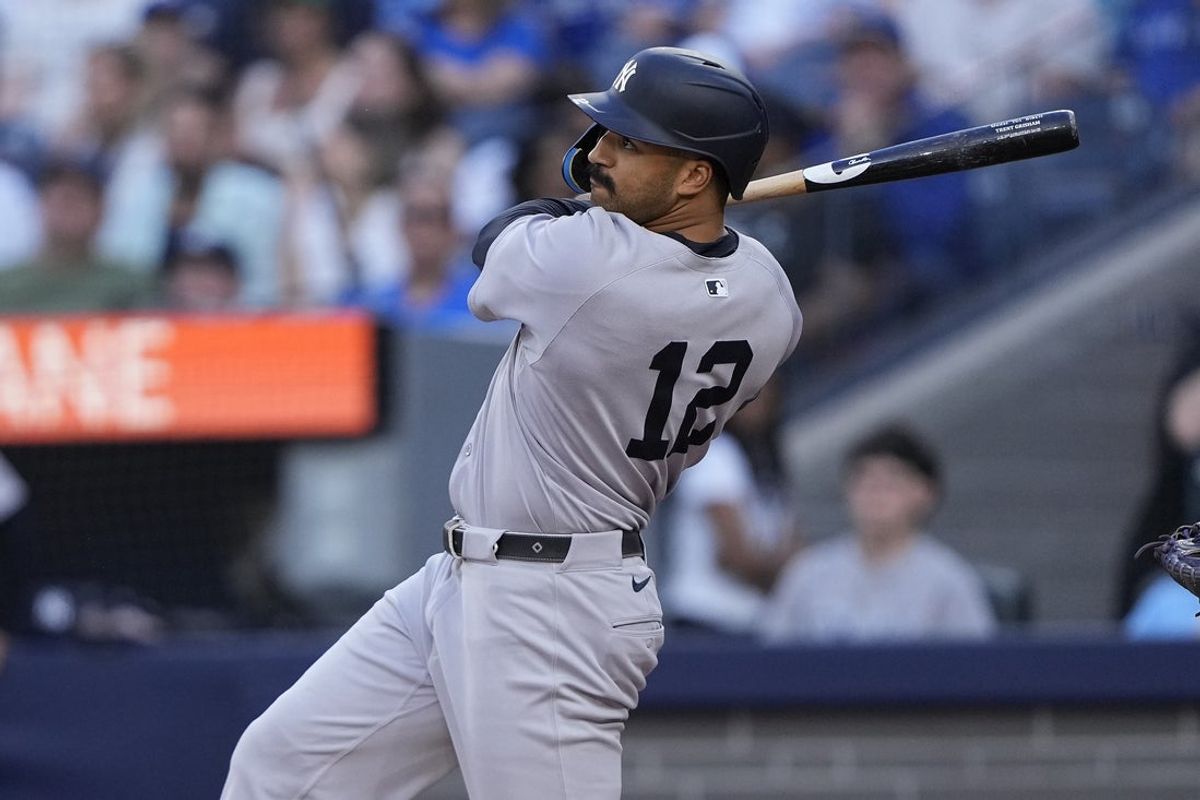 Jul 3, 2025; Toronto, Ontario, CAN; New York Yankees center fielder Trent Grisham (12) hits a solo home run against the Toronto Blue Jays during the third inning at Rogers Centre. Mandatory Credit: John E. Sokolowski-Imagn Images