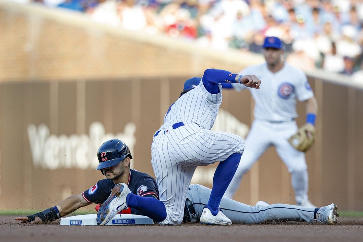 Jul 3, 2025; Chicago, Illinois, USA; Cleveland Guardians left fielder Steven Kwan (38) is caught stealing second base by Chicago Cubs shortstop Dansby Swanson (7) during the first inning at Wrigley Field. Mandatory Credit: Kamil Krzaczynski-Imagn Images