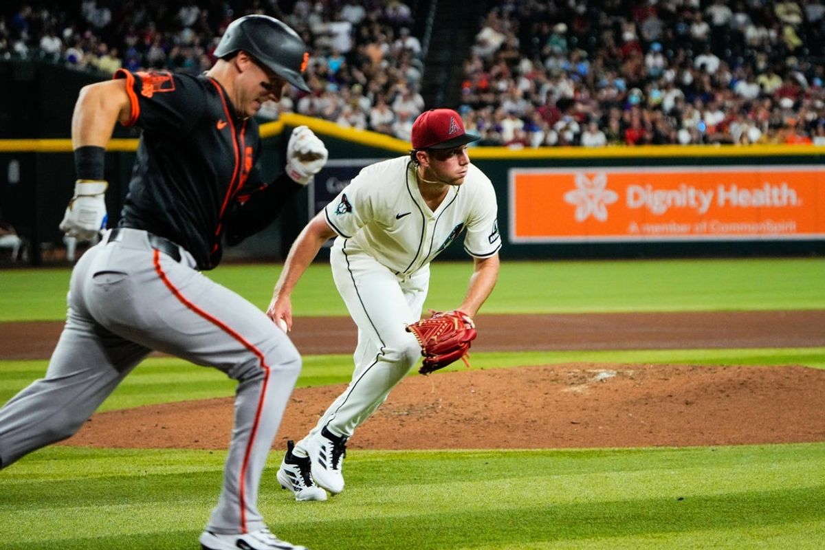 Jul 3, 2025; Phoenix, Arizona, USA; Arizona Diamondbacks pitcher Brandon Pfaadt (32) fields the ball during the fourth inning during a game between the Arizona Diamondbacks and the San Francisco Giants at Chase Field. Mandatory Credit: Arianna Grainey-Imagn Images
