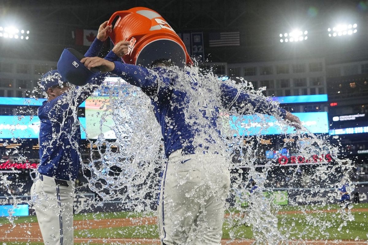 Jul 3, 2025; Toronto, Ontario, CAN; Toronto Blue Jays designated hitter George Springer (4) gets doused with ice water following a win over the New York Yankees at Rogers Centre. Mandatory Credit: John E. Sokolowski-Imagn Images