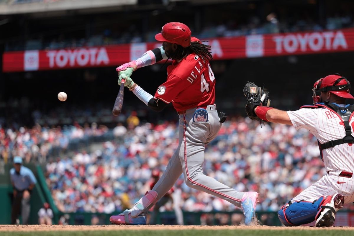 Jul 4, 2025; Philadelphia, Pennsylvania, USA; Cincinnati Reds shortstop Elly De La Cruz (44) hits an RBI single during the fourth inning against the Philadelphia Phillies at Citizens Bank Park. Mandatory Credit: Bill Streicher-Imagn Images