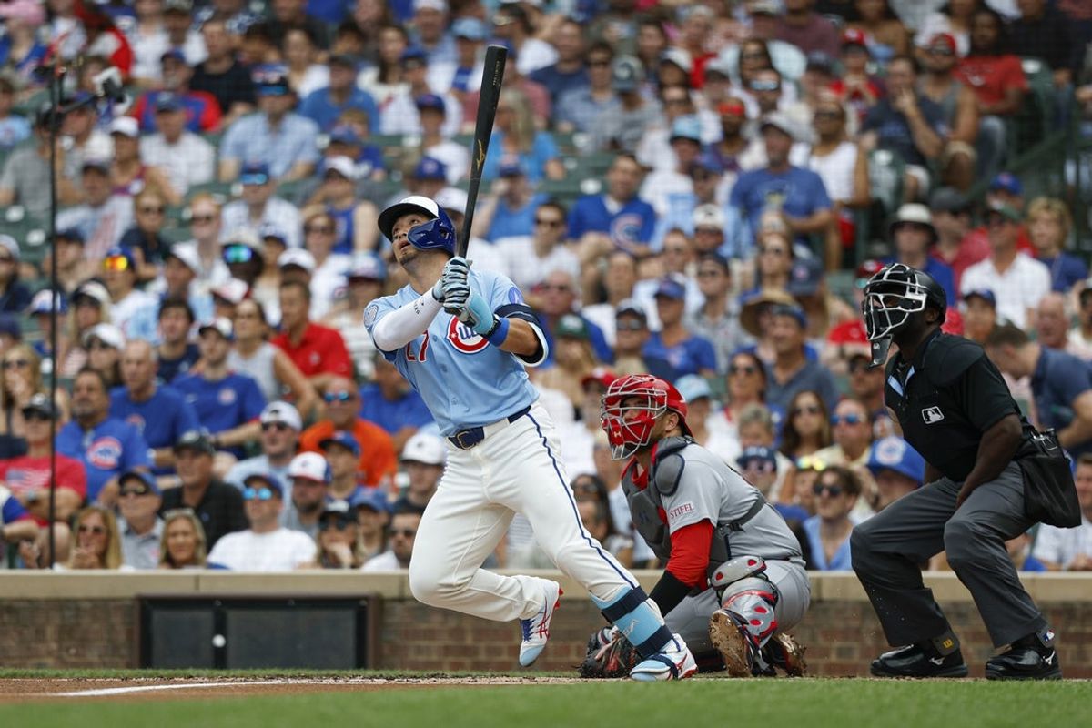 Jul 4, 2025; Chicago, Illinois, USA; Chicago Cubs designated hitter Seiya Suzuki (27) hits a solo home run against the St. Louis Cardinals during the first inning at Wrigley Field. Mandatory Credit: Kamil Krzaczynski-Imagn Images
