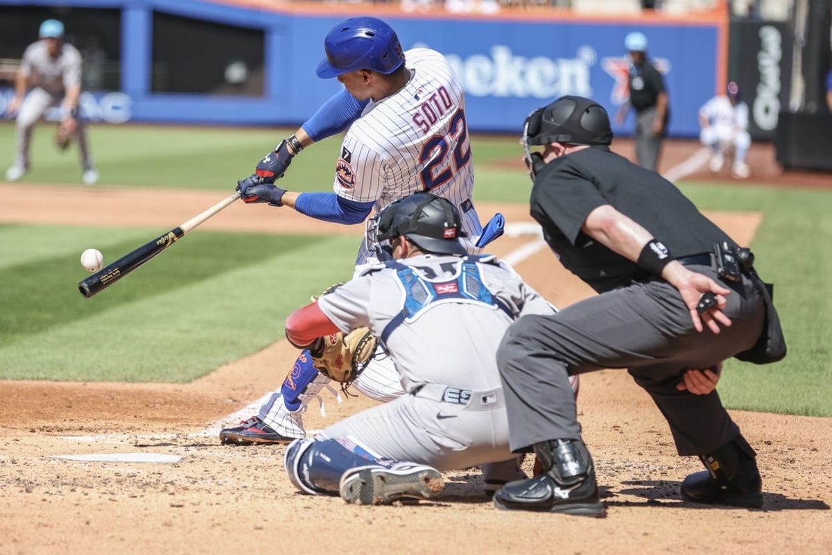 Jul 4, 2025; New York City, New York, USA;  New York Mets right fielder Juan Soto (22) hits a double in the third inning against the New York Yankees at Citi Field. Mandatory Credit: Wendell Cruz-Imagn Images