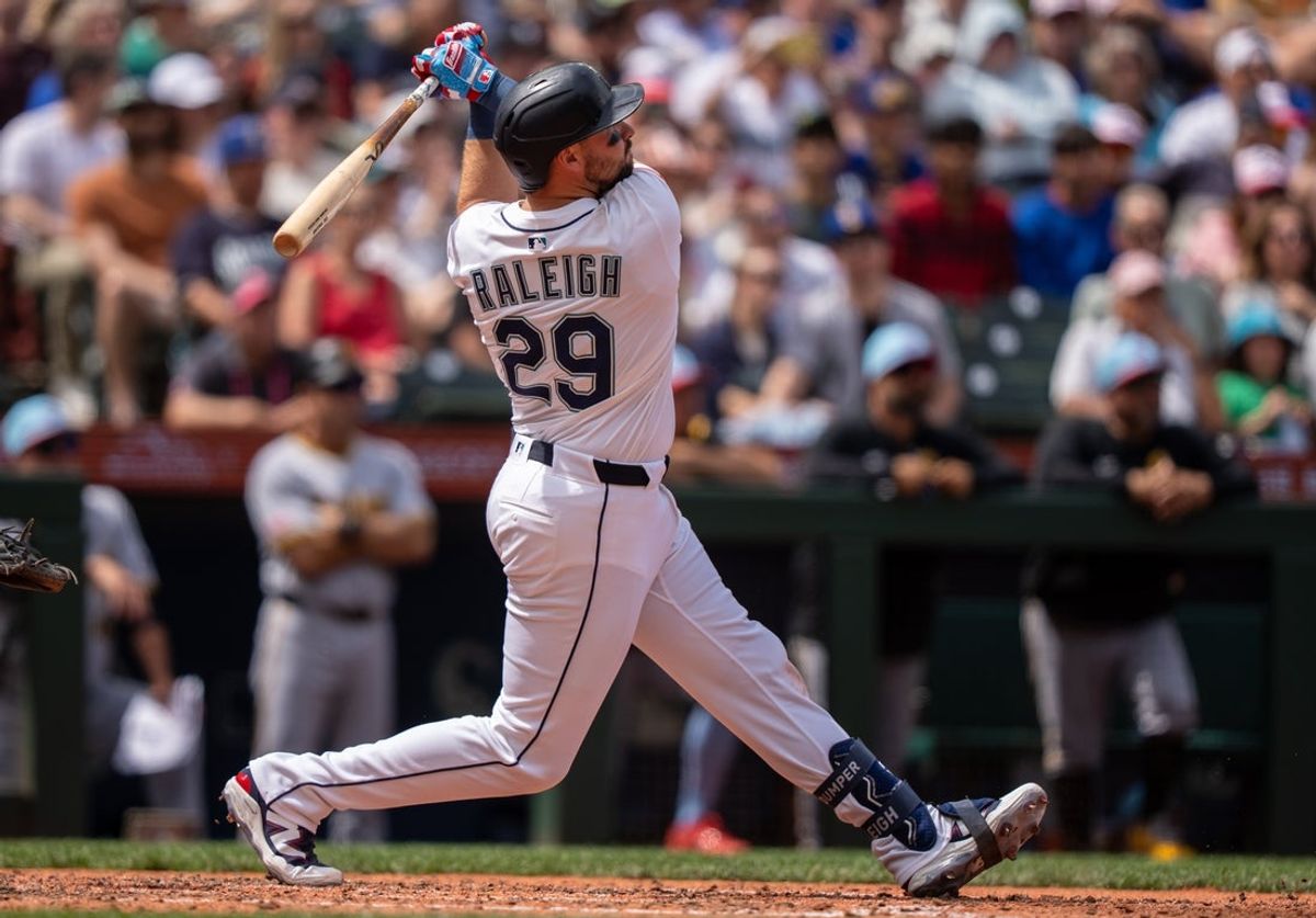 Jul 4, 2025; Seattle, Washington, USA; Seattle Mariners designated hitter Cal Raleigh (29) hits a solo home run during the sixth inning against the Pittsburgh Pirates  at T-Mobile Park. Mandatory Credit: Stephen Brashear-Imagn Images