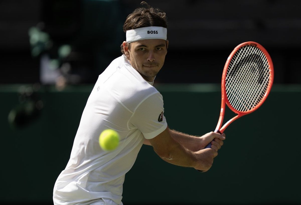 Jul 4, 2025; Wimbledon, United Kingdom;  Taylor Fritz of the United States returns a shot during his match against Alejandro Davidovich Fokina of Spain on day five at the All England Lawn Tennis and Croquet Club. Mandatory Credit: Susan Mullane-Imagn Images