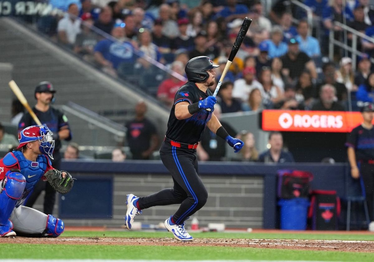 Jul 4, 2025; Toronto, Ontario, CAN; Toronto Blue Jays right fielder Addison Barger (47) gets on first base on a fielder’s choice scoring a run against the Los Angeles Angels during the sixth inning at Rogers Centre. Mandatory Credit: Nick Turchiaro-Imagn Images
