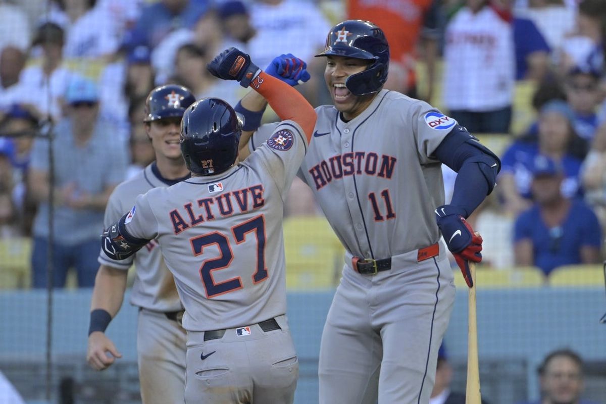 Jul 4, 2025; Los Angeles, California, USA; Houston Astros outfielder Jose Altuve (27) celebrates a 2 run home run with outfielder Cam Smith (11) during the third inning against the Los Angeles Dodgers at Dodger Stadium. Mandatory Credit: Jayne Kamin-Oncea-Imagn Images