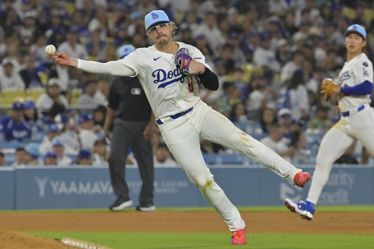 Jul 4, 2025; Los Angeles, California, USA; Los Angeles Dodgers third baseman Enrique Hernandez (8) throws Houston Astros left fielder Shay Whitcomb (10) out at first in the eighth inning at Dodger Stadium. Mandatory Credit: Jayne Kamin-Oncea-Imagn Images