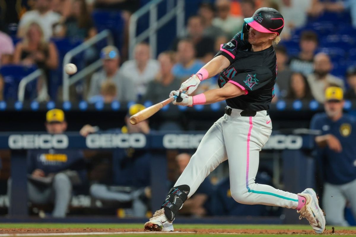 Jul 5, 2025; Miami, Florida, USA; Miami Marlins left fielder Kyle Stowers (28) hits a solo home run against the Milwaukee Brewers during the second inning at loanDepot Park. Mandatory Credit: Sam Navarro-Imagn Images