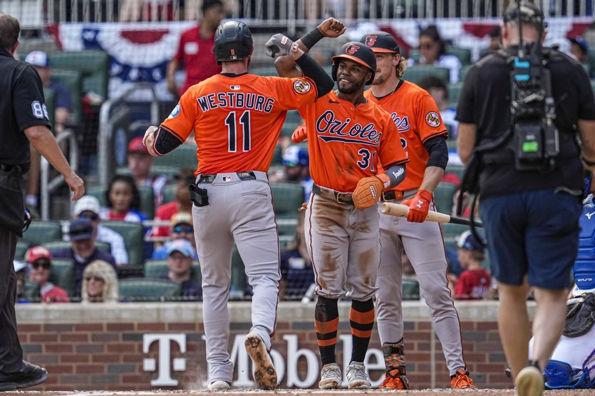 Jul 5, 2025; Cumberland, Georgia, USA; Baltimore Orioles third baseman Jordan Westburg (11) reacts with center fielder Cedric Mullins (31) after hitting a two run home run against the Atlanta Braves during the third inning at Truist Park. Mandatory Credit: Dale Zanine-Imagn Images