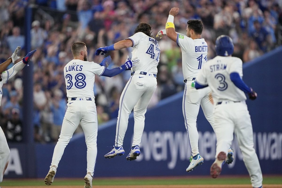 Jul 5, 2025; Toronto, Ontario, CAN; Toronto Blue Jays center fielder Nathan Lukes (38) and shortstop Bo Bichette (11) congratulate right fielder Addison Barger (47) after his walk off single against the Los Angeles Angels during the 11th inning at Rogers Centre. Mandatory Credit: John E. Sokolowski-Imagn Images