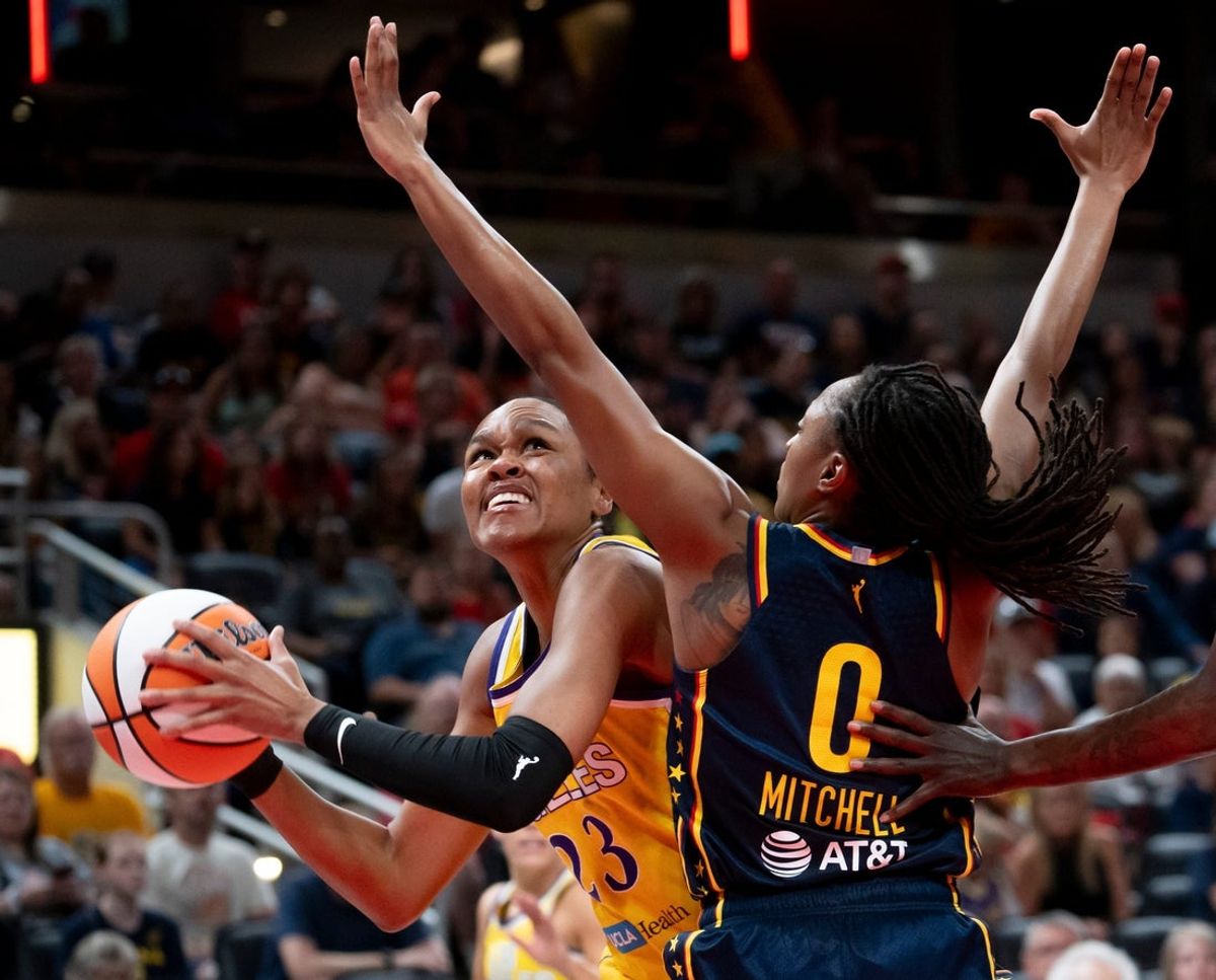 Indiana Fever guard Kelsey Mitchell (0) guards Los Angeles Sparks forward Azura Stevens (23) Saturday, July 5, 2025, at Gainbridge Fieldhouse in Indianapolis.