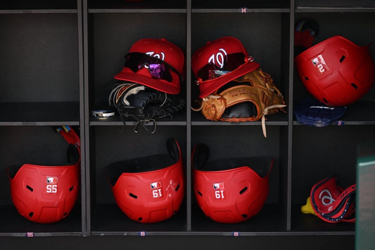 Jul 6, 2025; Washington, District of Columbia, USA; Washington Nationals batting helmets, gloves and caps sit in the dugout before a game against the Boston Red Sox at Nationals Park. Mandatory Credit: Rafael Suanes-Imagn Images