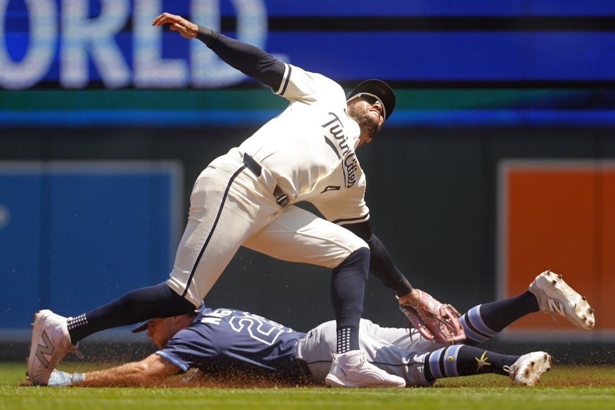 Jul 6, 2025; Minneapolis, Minnesota, USA; Minnesota Twins second baseman Willi Castro (50) tags out Tampa Bay Rays left fielder Jake Mangum (28) on a stolen base attempt in the second inning at Target Field. Mandatory Credit: Bruce Kluckhohn-Imagn Images