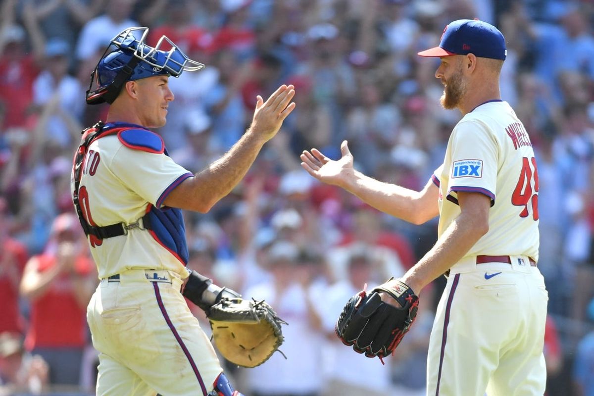 Jul 6, 2025; Philadelphia, Pennsylvania, USA; Philadelphia Phillies catcher J.T. Realmuto (10) and pitcher Zack Wheeler (45) celebrate win against the Cincinnati Reds at Citizens Bank Park. Mandatory Credit: Eric Hartline-Imagn Images