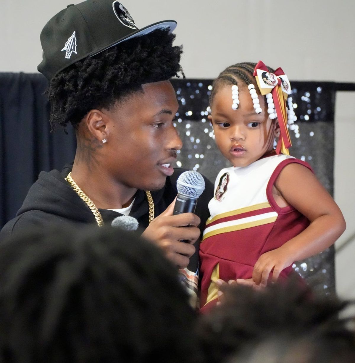 Friends and family celebrate after Booker High defensive end/wide receiver Chauncey Kennon announces he has selected Florida State University to commit to during a party Sunday afternoon, July 6, 2025 at the DeSoto Boys and Girls Club in Bradenton.