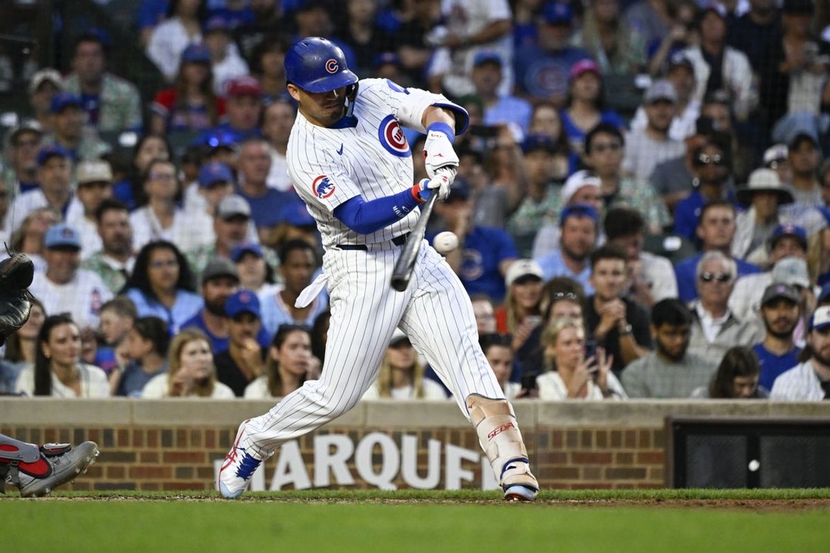 Jul 6, 2025; Chicago, Illinois, USA;  Chicago Cubs outfielder Seiya Suzuki (27) hits an RBI double against the St. Louis Cardinals during the third inning at Wrigley Field. Mandatory Credit: Matt Marton-Imagn Images