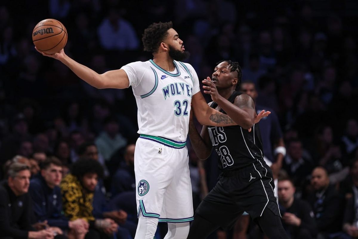 Jan 25, 2024; Brooklyn, New York, USA; Minnesota Timberwolves center Karl-Anthony Towns (32) shields the ball from Brooklyn Nets forward Dorian Finney-Smith (28) during the first quarter at Barclays Center.