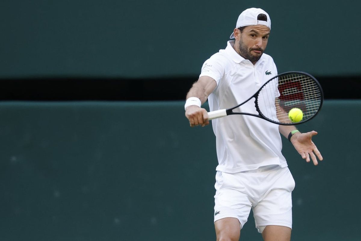 Jul 7, 2025; Wimbledon, United Kingdom; Grigor Dimitrov (BUL) hits a backhand against Jannik Sinner (ITA)(not pictured) on day eight of The Championships Wimbledon 2025 at All England Lawn Tennis and Croquet Club. Mandatory Credit: Geoff Burke-Imagn Images