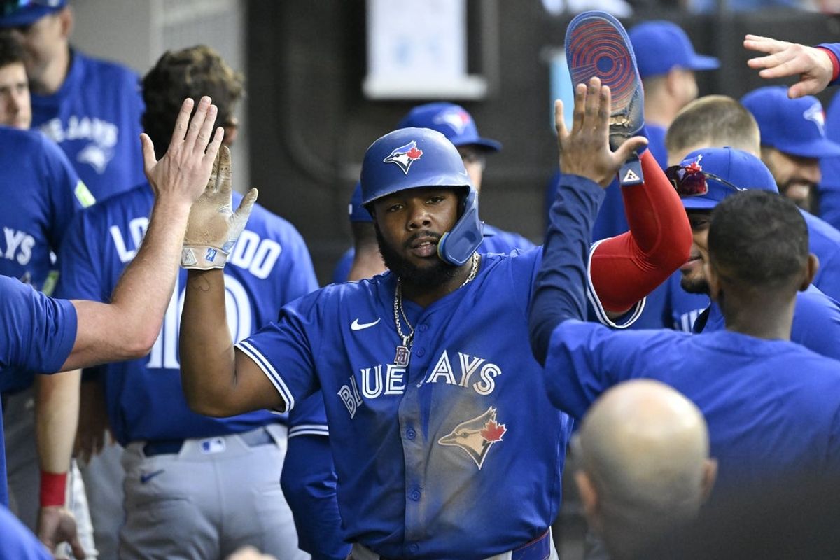 Jul 7, 2025; Chicago, Illinois, USA;  Toronto Blue Jays first base Vladimir Guerrero Jr. (27) celebrates in the dugout after he  scores during the fourth inning against the Chicago White Sox at Rate Field. Mandatory Credit: Matt Marton-Imagn Images