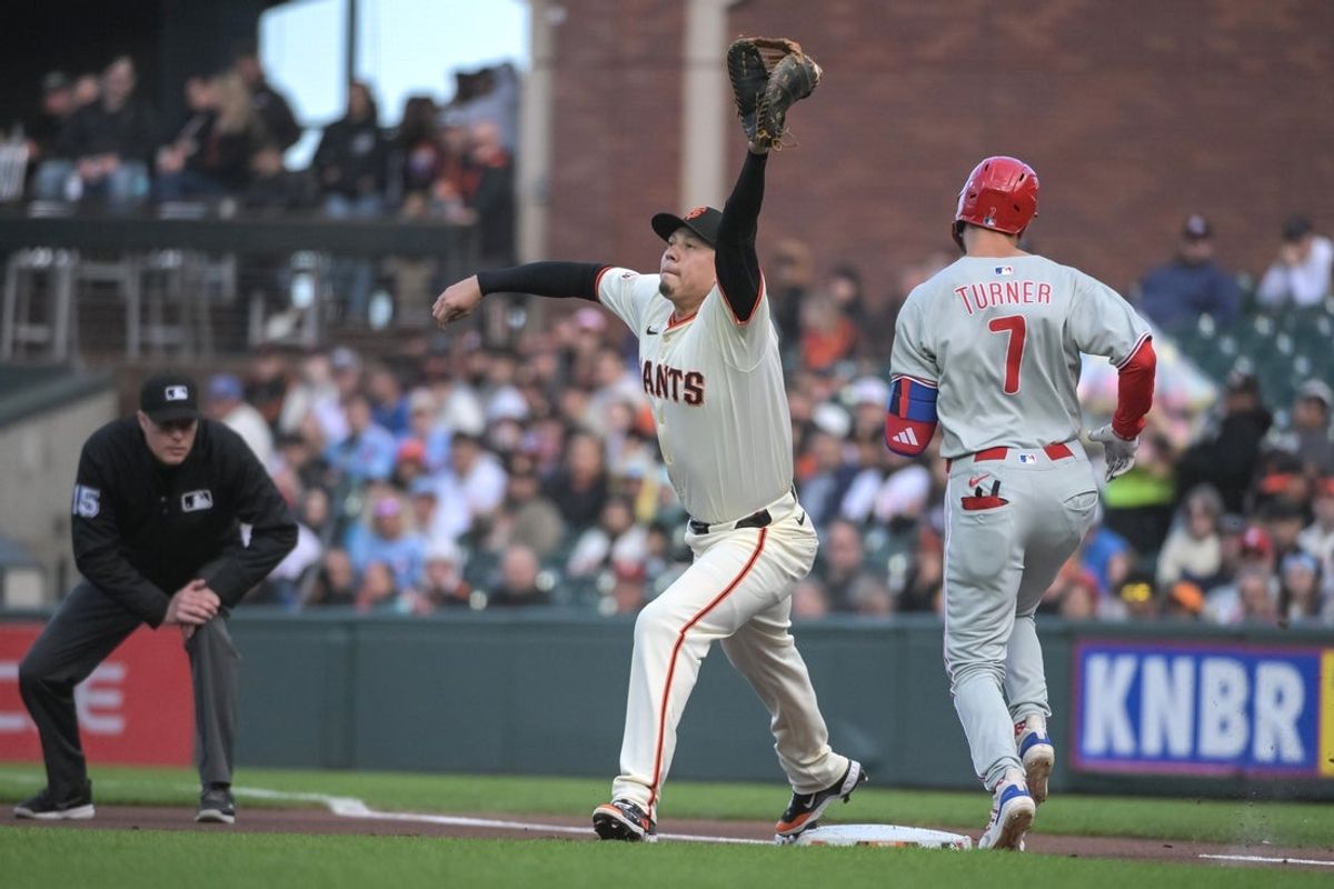 Jul 7, 2025; San Francisco, California, USA; San Francisco Giants first baseman Wilmer Flores (41) makes the out at first base during the first inning of the game against the Philadelphia Phillies at Oracle Park. Mandatory Credit: Ed Szczepanski-Imagn Images
